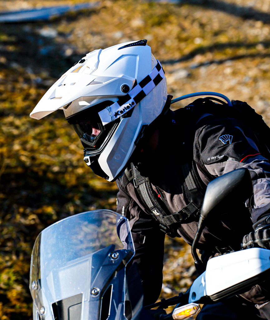 White Caberg Tanami helmet being worn by a man on his motorbike