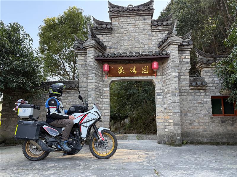 Rider wearing LEVO X while on his bike, looking at a Chinese wall